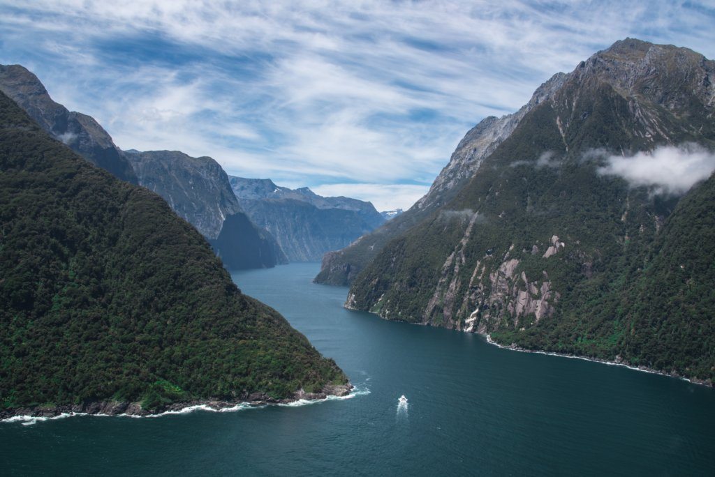 An aerial view of the Milford Sound weaving between two mountainous peaks