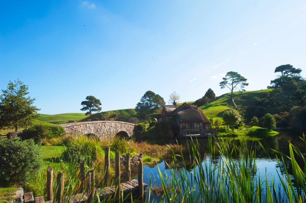 The view over the lake to the Green Dragon Inn, in Hobbiton