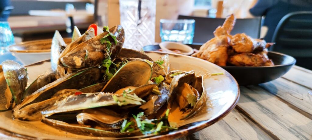 Plates of fresh seafood on wooden table