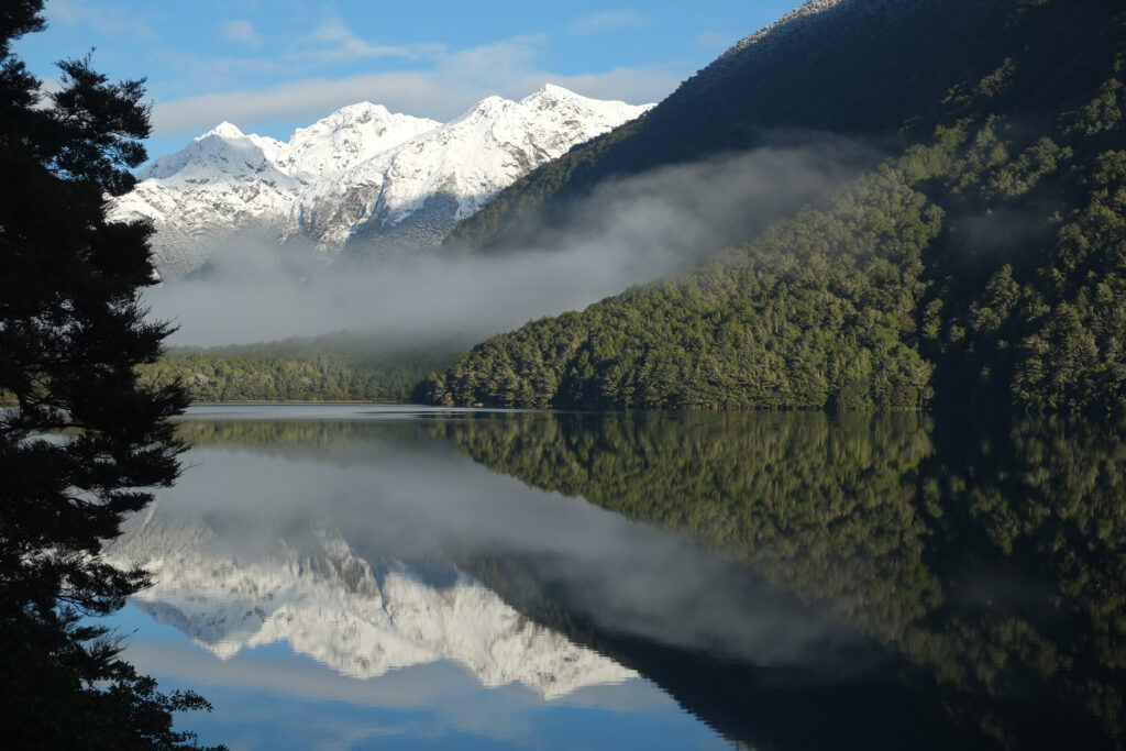 Disappearing Peaks reflecting in Lake Gunn on a calm winter morning